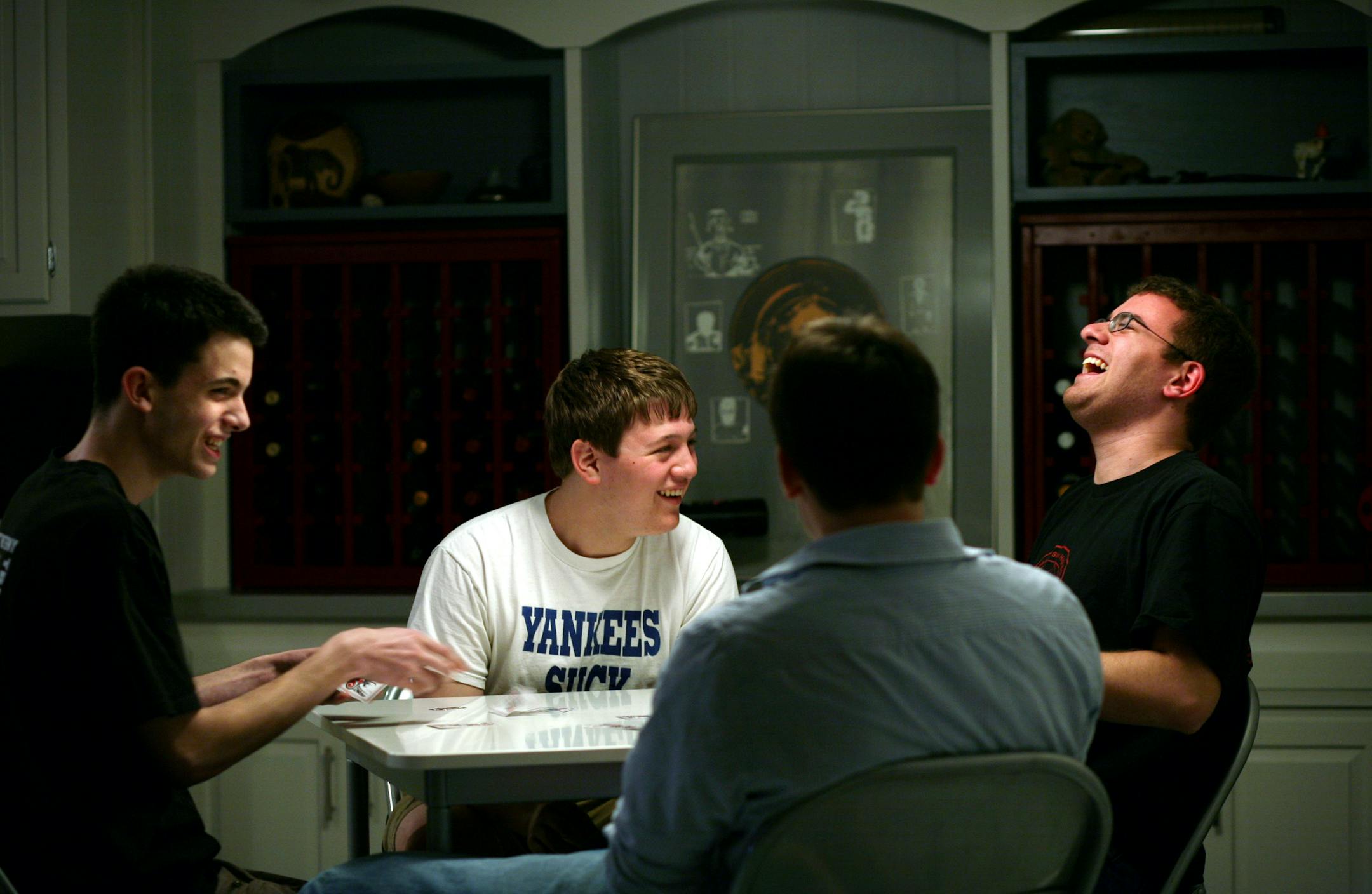 High school seniors Abram Jopp, Nat Olson, Peter Knudson and Ben Weitz, left to right, played bridge in Weitz's basement.