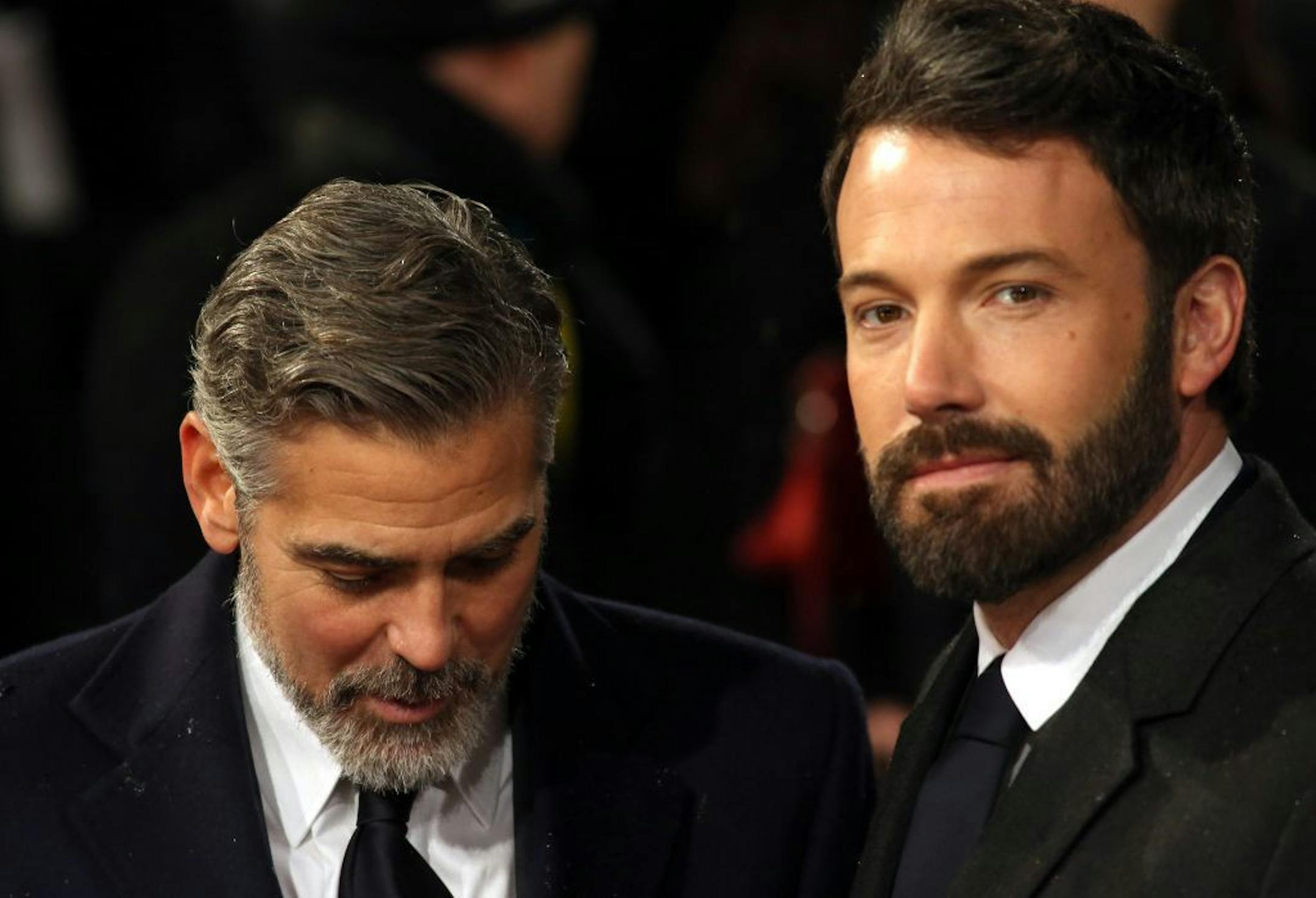 George Clooney, left, and Ben Affleck arrive for the BAFTA Film Awards at the Royal Opera House on Sunday, Feb. 10, 2013, in London.