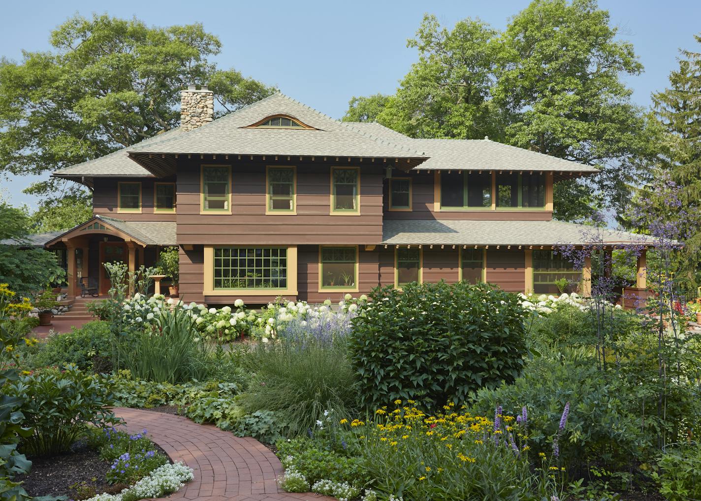 Perennial gardens at the entry to the Craftsman-style home.