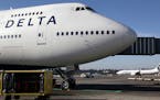 In this Oct. 9, 2012 file photo, Delta Air Lines 747-400 airplane sits parked at Seattle-Tacoma International Airport in Seattle. Delta Airlines on Mo