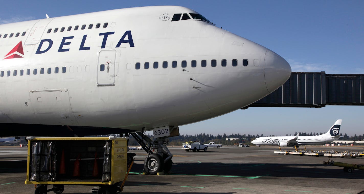 In this Oct. 9, 2012 file photo, Delta Air Lines 747-400 airplane sits parked at Seattle-Tacoma International Airport in Seattle. Delta Airlines on Monday, Aug. 3, 2015 said that it would no longer accept lion, leopard, elephant, rhinoceros and buffalo hunting trophies. (AP Photo/Ted S. Warren, File)