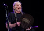 Willie Nelson tipped his hat to the crowd while taking the stage with his band as he played the amphitheater at Treasure Island casino Friday, June 9,