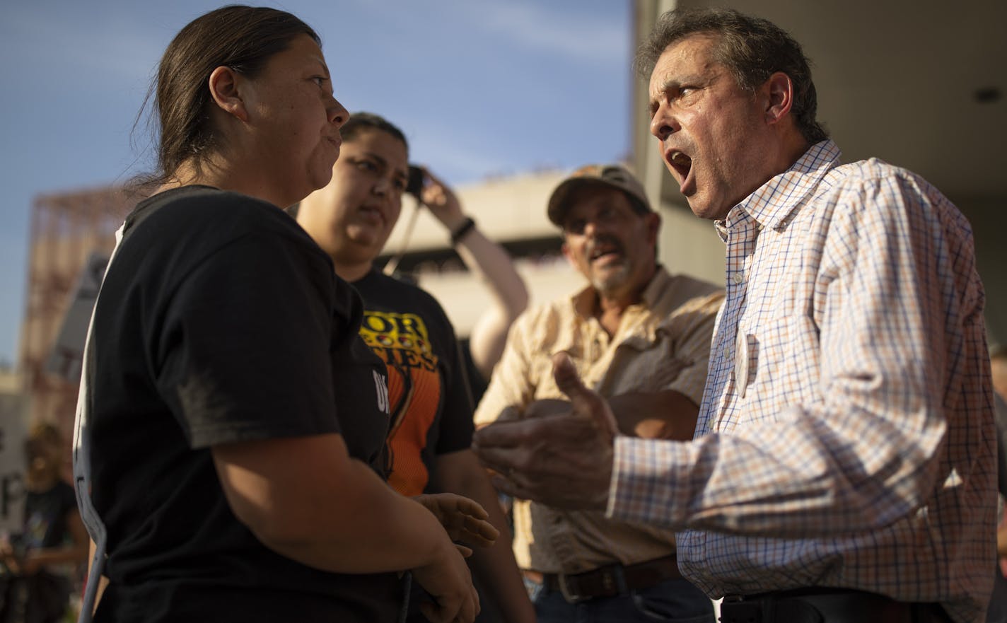 Aaron Camacho, left, and Pastor Dan Stone of Duluth discussed Trump policies Wednesday.