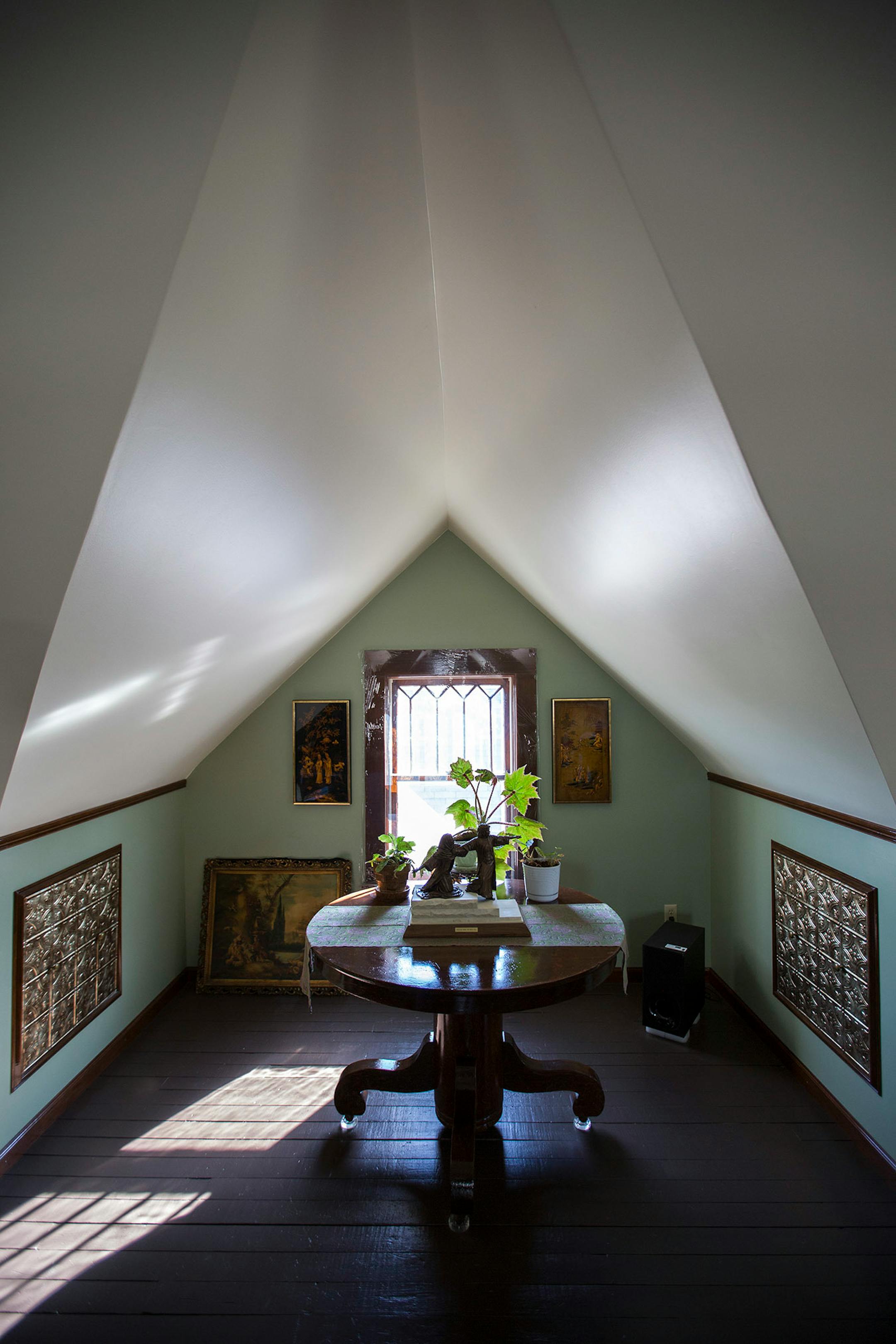 The tin-tiled doors open to deep storage areas under the sloped walls.