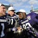 Northwestern defensive lineman Brian Arnfelt (91) and Bo Cisek (1) holds the trophy while their teammate Will Hampton (92) kisses it after the Gator B