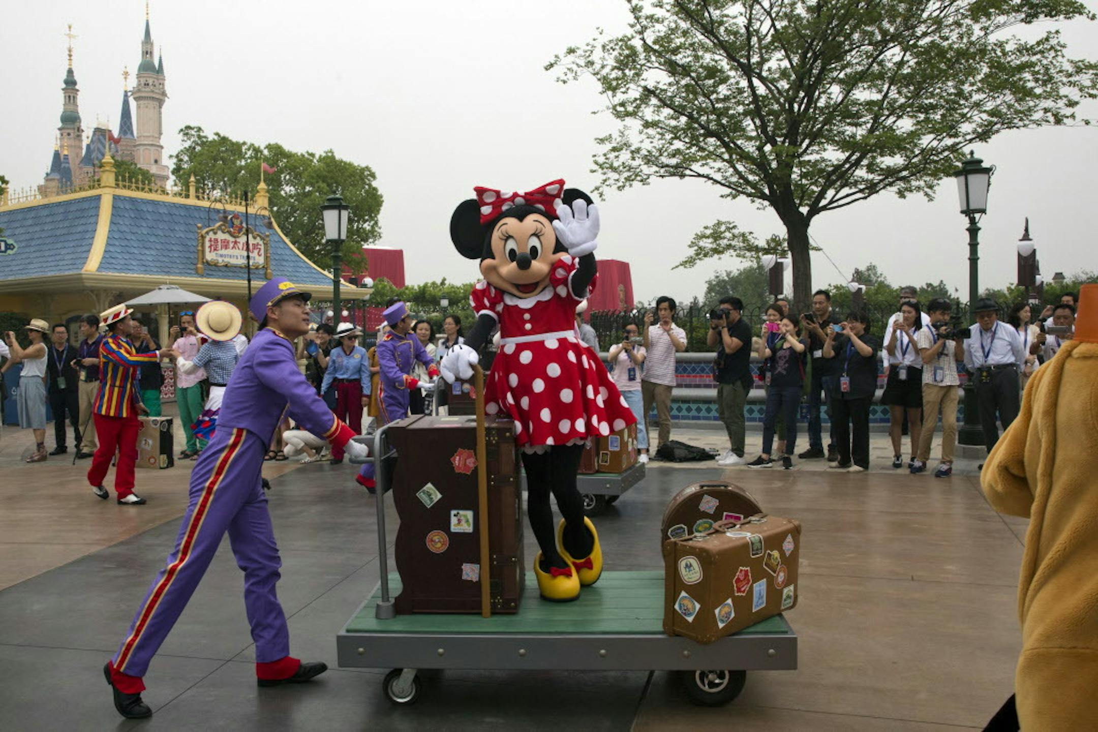 A Disney character takes part in a parade on the eve of the opening of the Disney Resorts in Shanghai, China, Wednesday, June 15, 2016. The debut of Shanghai Disneyland offers Walt Disney Co. "incredible potential" for boosting its brand in the world's most populous market, Disney's chief executive said Wednesday ahead of Thursday's grand opening for the $5.5 billion park. (AP Photo/Ng Han Guan)