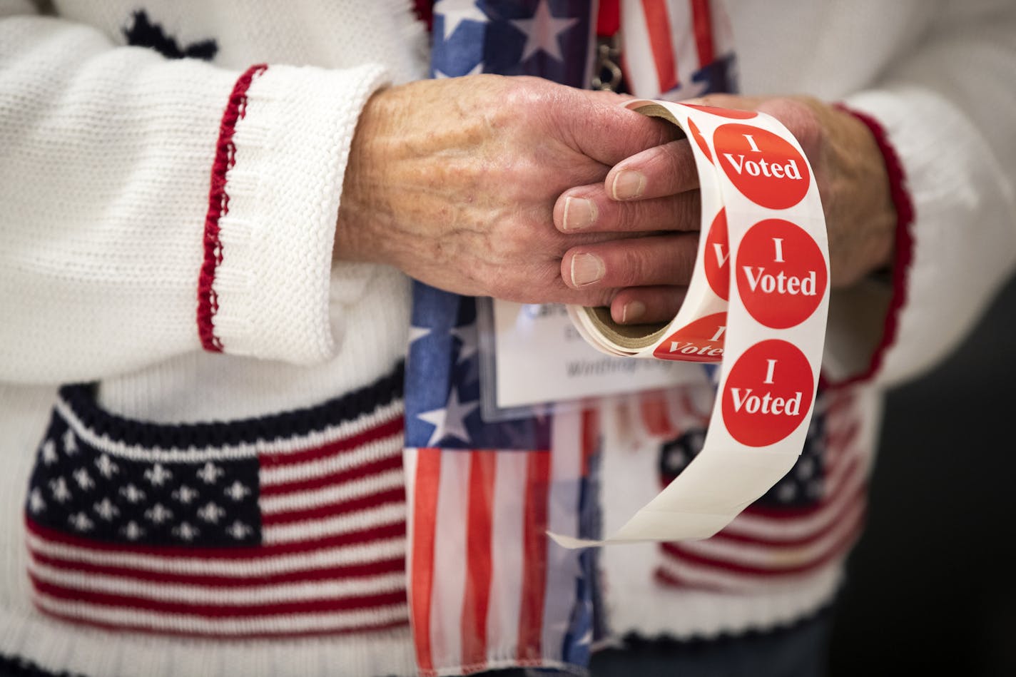 Election official Carol Messner gives out stickers at Winthrop Community Hall. ] LEILA NAVIDI ¥ leila.navidi@startribune.com BACKGROUND INFORMATION: Election Day voting in Sibley County on Tuesday, November 6, 2018. At 91.4 percent, in 2016, Sibley County had one of the highest percentage of votes cast at a polling place of any county in the state.