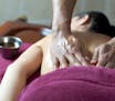 A young woman is lying on a massage table and getting an Ayurveda treatment with herbal oil. istock
