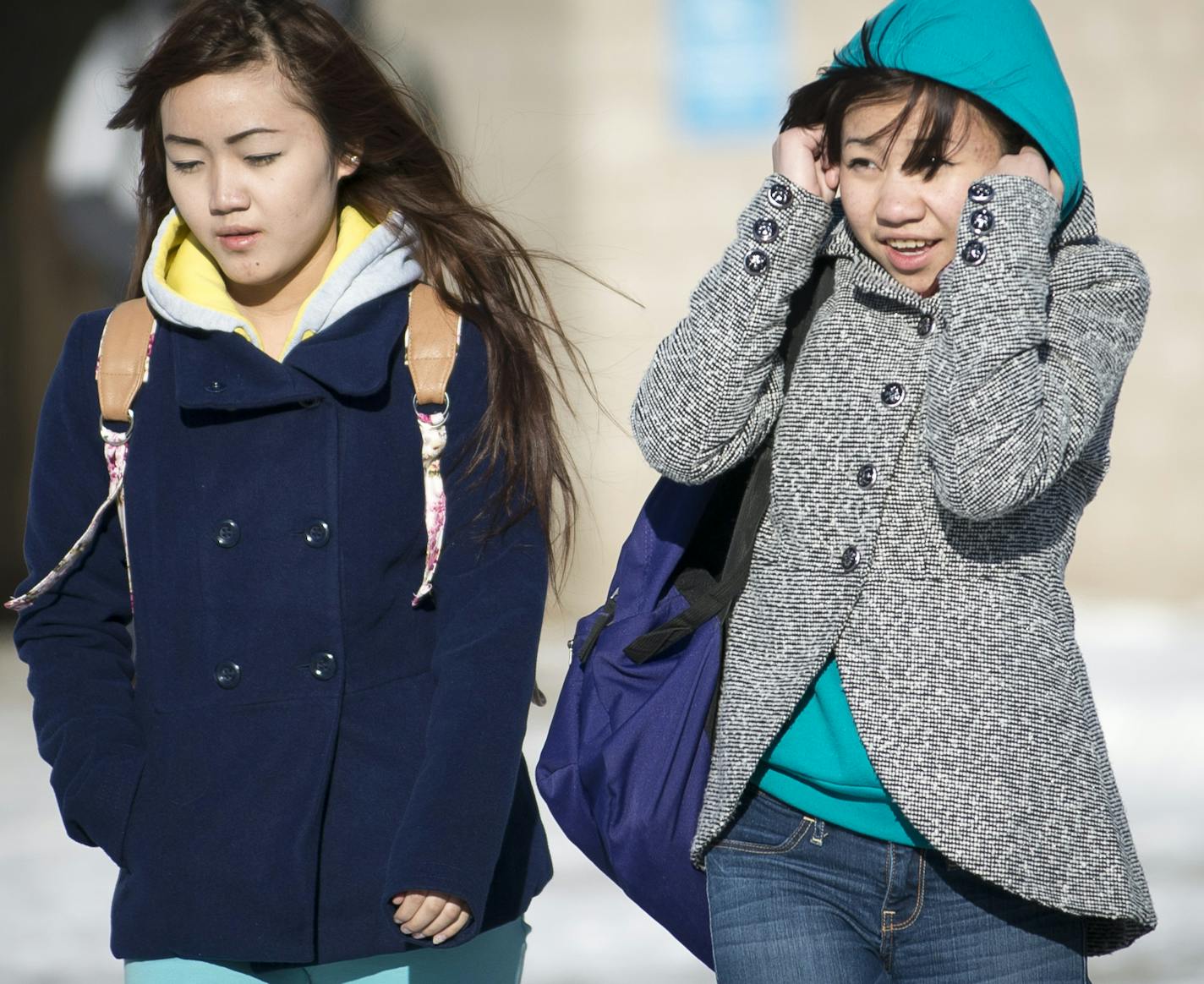 From left, Tang Moua,15, and Xong Moua, 14, make their way to the bus in the bitter cold after classes at Central High School let out on Wednesday afternoon. ] (Aaron Lavinsky | StarTribune) Students at Central High School in St. Paul brave the cold as they are let out of class on Wednesday, Jan. 7, 2014. With temperature below zero, the Minneapolis School District decided to give students and faculty a day off. The St. Paul School district went ahead with planned classes.