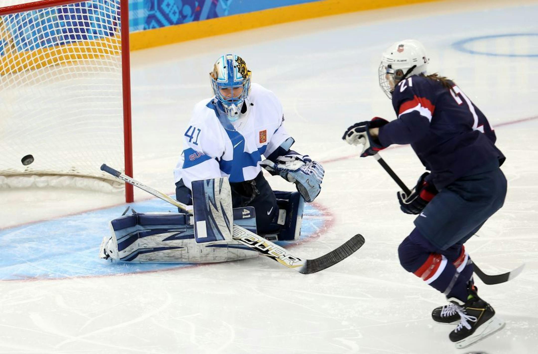 U.S. forward Hilary Knight (21) scores a goal against Finland goalkeeper Noora Raty (41) during the first period in a women's hockey game at the Winter Olympics in Sochi, Russia, Saturday, February 8, 2014.