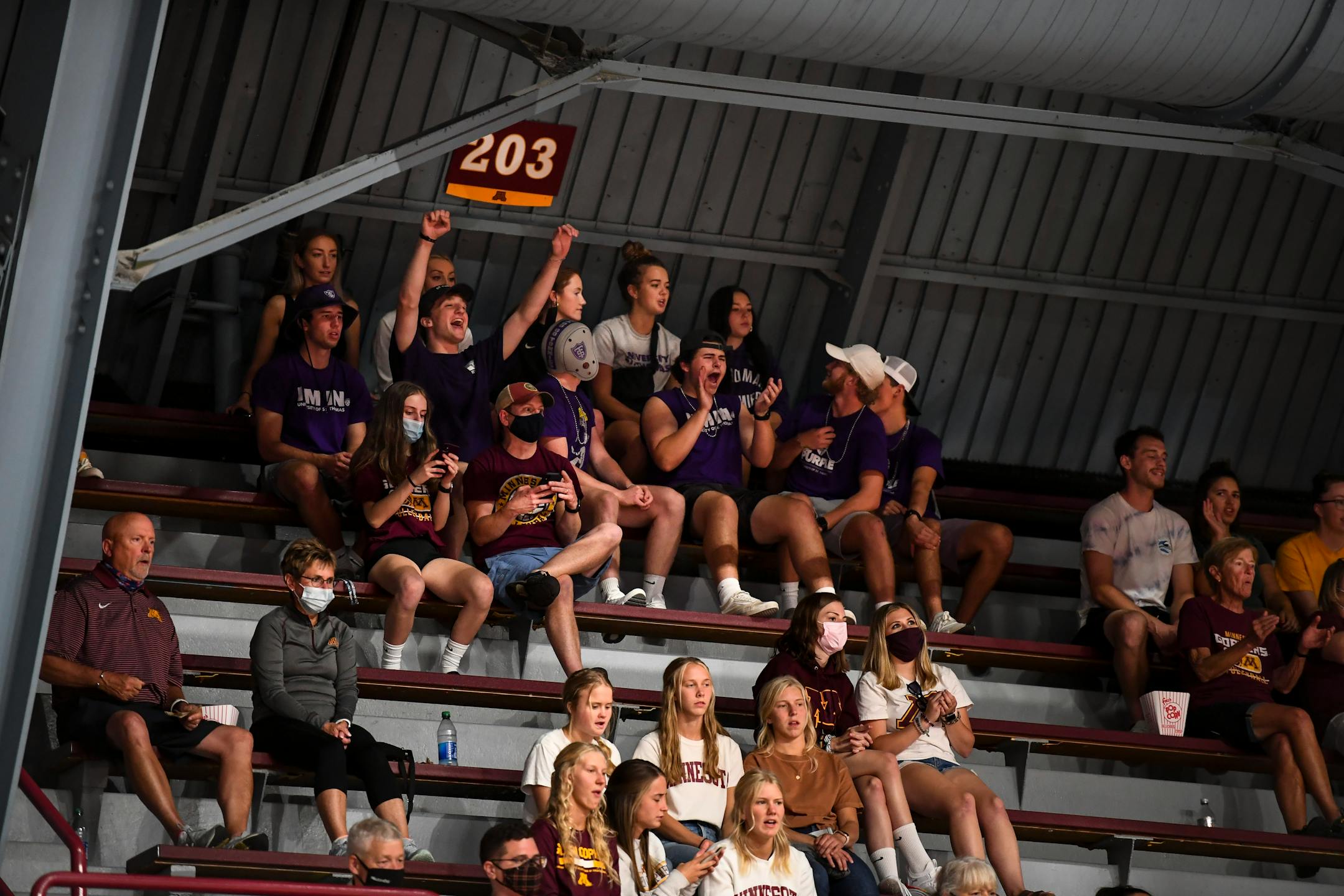 A pocket of St. Thomas fans celebrated a point scored by the Tommies in the first set against the University of Minnesota Gophers Thursday night.