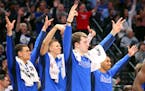 Dallas forward Luka Doncic (center) and the rest of the bench react after a three-pointer by Justin Jackson against the Timberwolves during the second