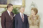 President Jimmy Carter greets President-elect Ronald Reagan and Nancy Reagan on their visit to the White House in Washington, in the oval office, Nov.