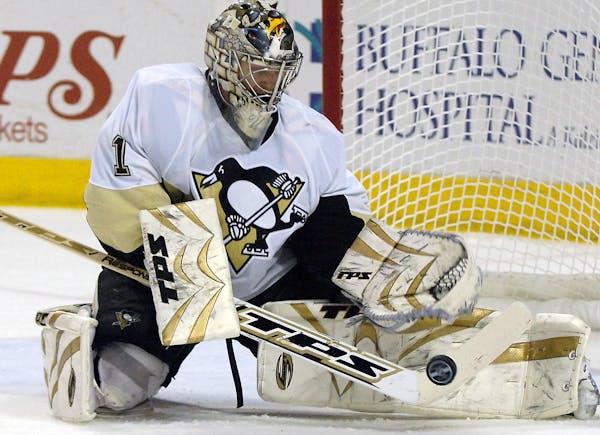 Pittsburgh Penguins goalie John Curry makes a save on the Buffalo Sabres during the first period of an NHL hockey game in Buffalo, N.Y. on Friday, Nov
