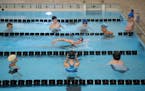 Other team members watch as Zoe Shorter as she demonstrates a kick turn during a Minneapolis Lake Monsters practice Thursday night at Southwest High S
