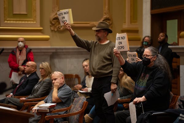 Audience members reacted as the committee voted to approve the ordinance during their meeting in Minneapolis City Hall Wednesday, Nov. 30, 2022. The M