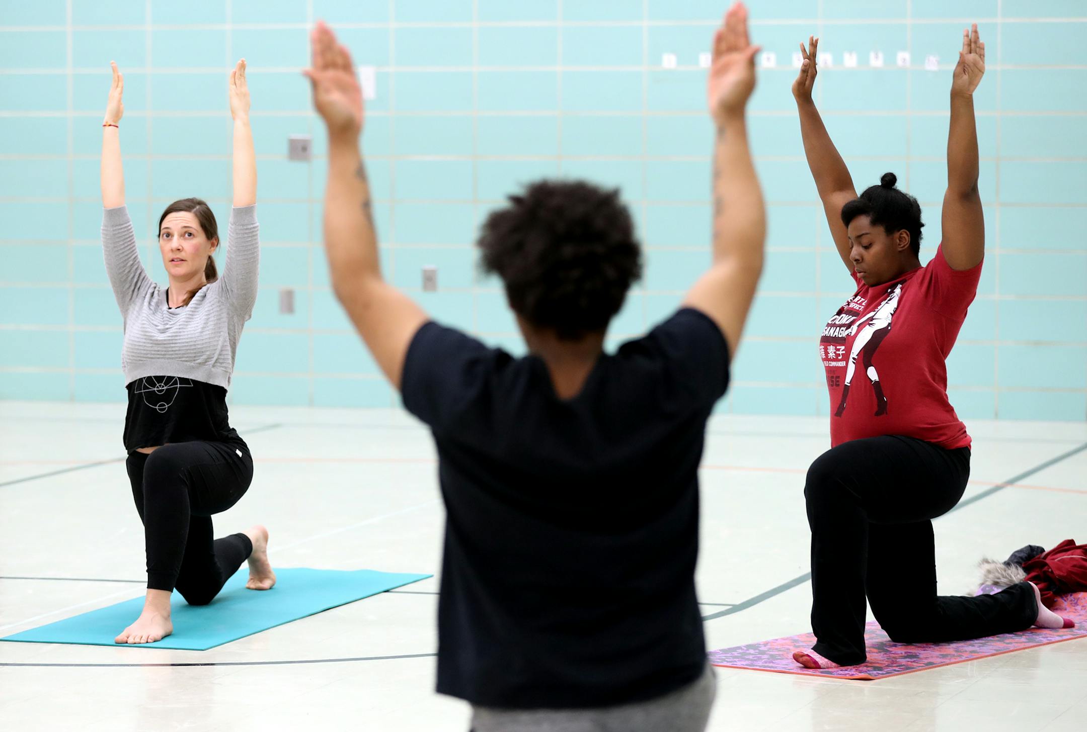 Yoga instructor Kelly La Frenier, left, teaches a class to a group of boys through The Link. Jasmine Wong, right, a youth specialist with The Link, also participates in class. ] LEILA NAVIDI • leila.navidi@startribune.com BACKGROUND INFORMATION: Yoga instructor Kelly La Frenier teaches a class to a group of boys through The Link in Brooklyn Park on Tuesday, February 13, 2018. A Minneapolis yoga studio is bringing weekly yoga classes to boys who are on probation in Hennepin County, teachin