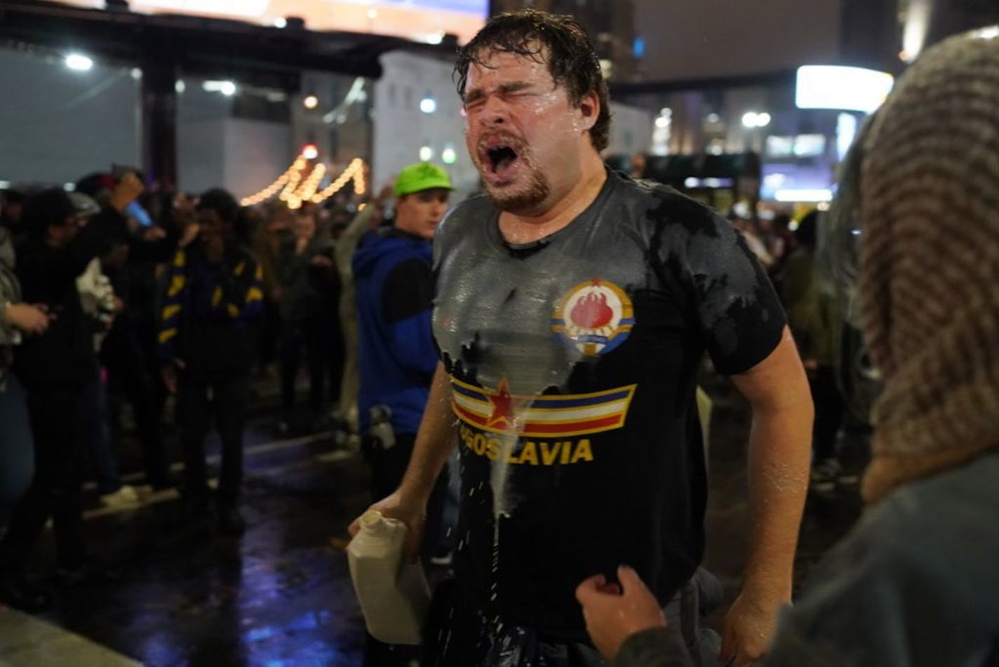 A protester poured milk on his face after being pepper spray led by police outside the Target Center as President Donald Trump visits Minneapolis, Minn., for a campaign rally on October 10, 2019.