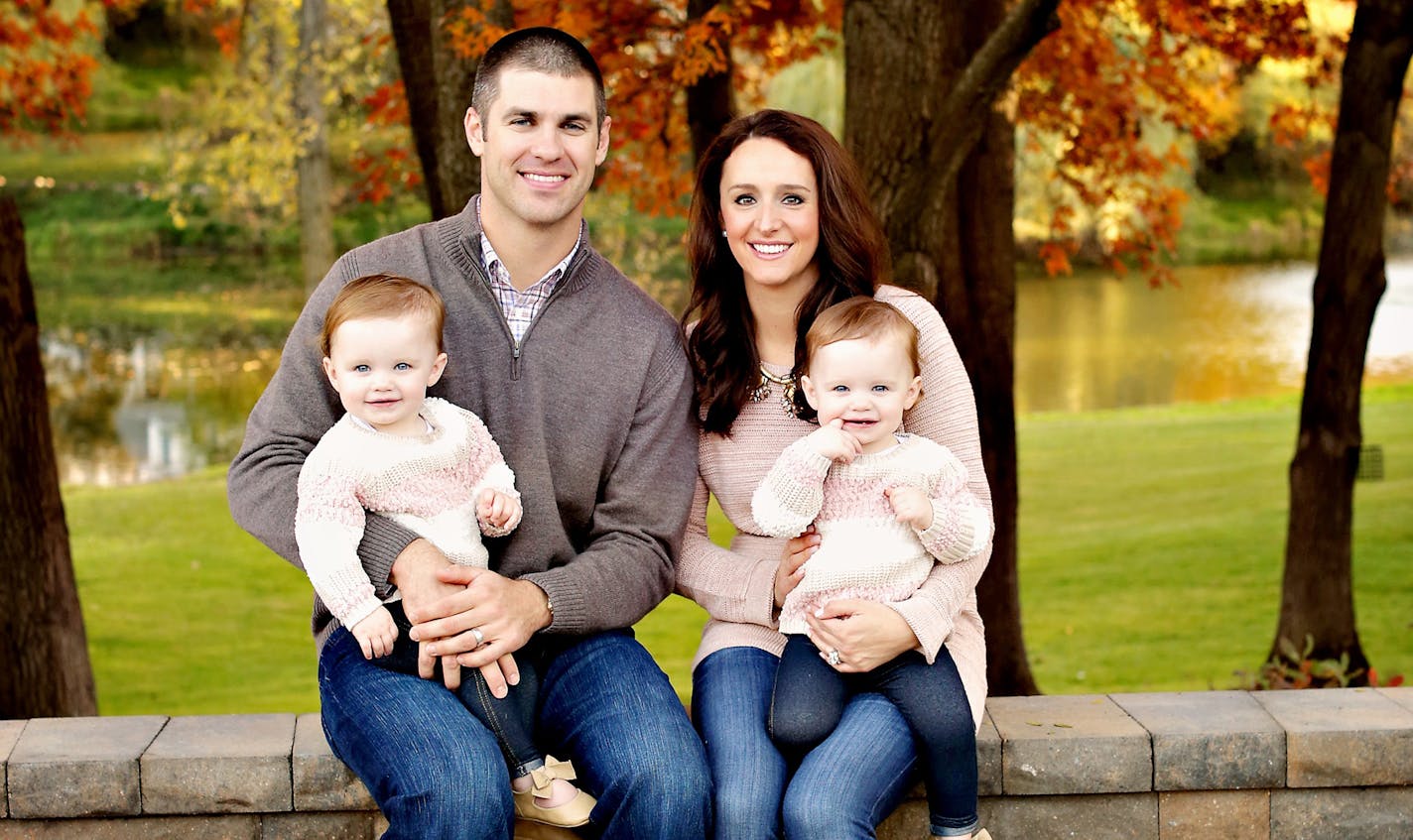 Joe and Maddie Mauer, with their twins Maren (left) and Emily, are shown in this photo taken by bellasaluti photography of Tonka Bay and provided by Cretin-Derham Hall Traditions magazine.