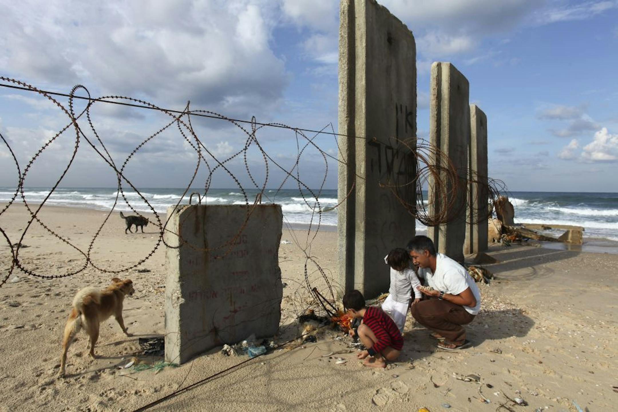 Shai Hathuel takes his children to the beach near the border with Gaza to enjoy the cease-fire, in Israel, Nov. 24 2012.
