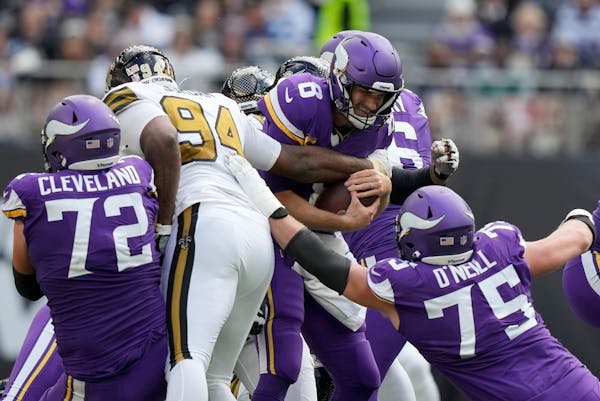 Vikings quarterback Kirk Cousins (8) was sacked three times against the Saints in London on Sunday. 