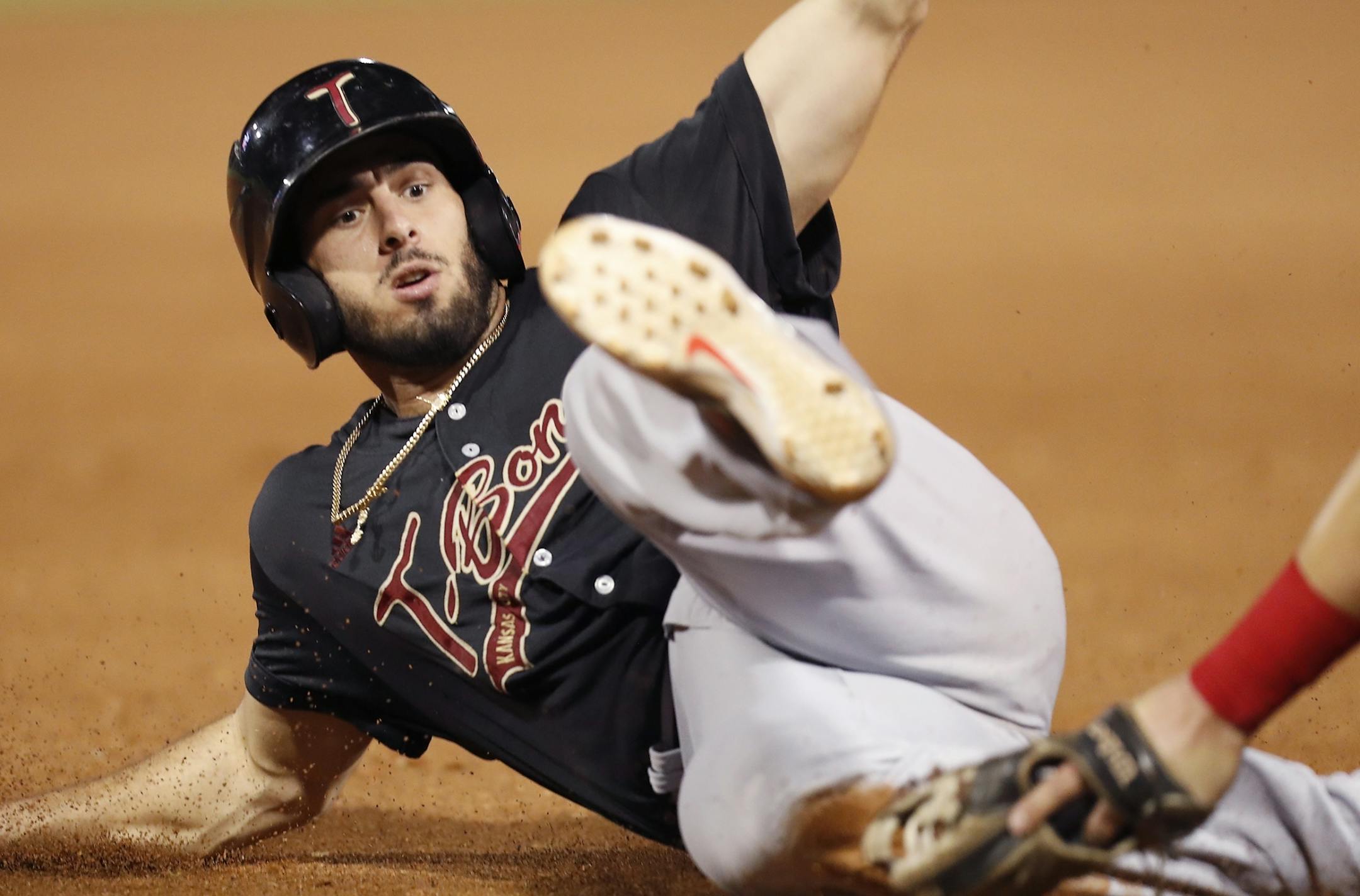 Kansas City's Adrian Nieto is tagged out by Dante Nichette Jr. at third base.