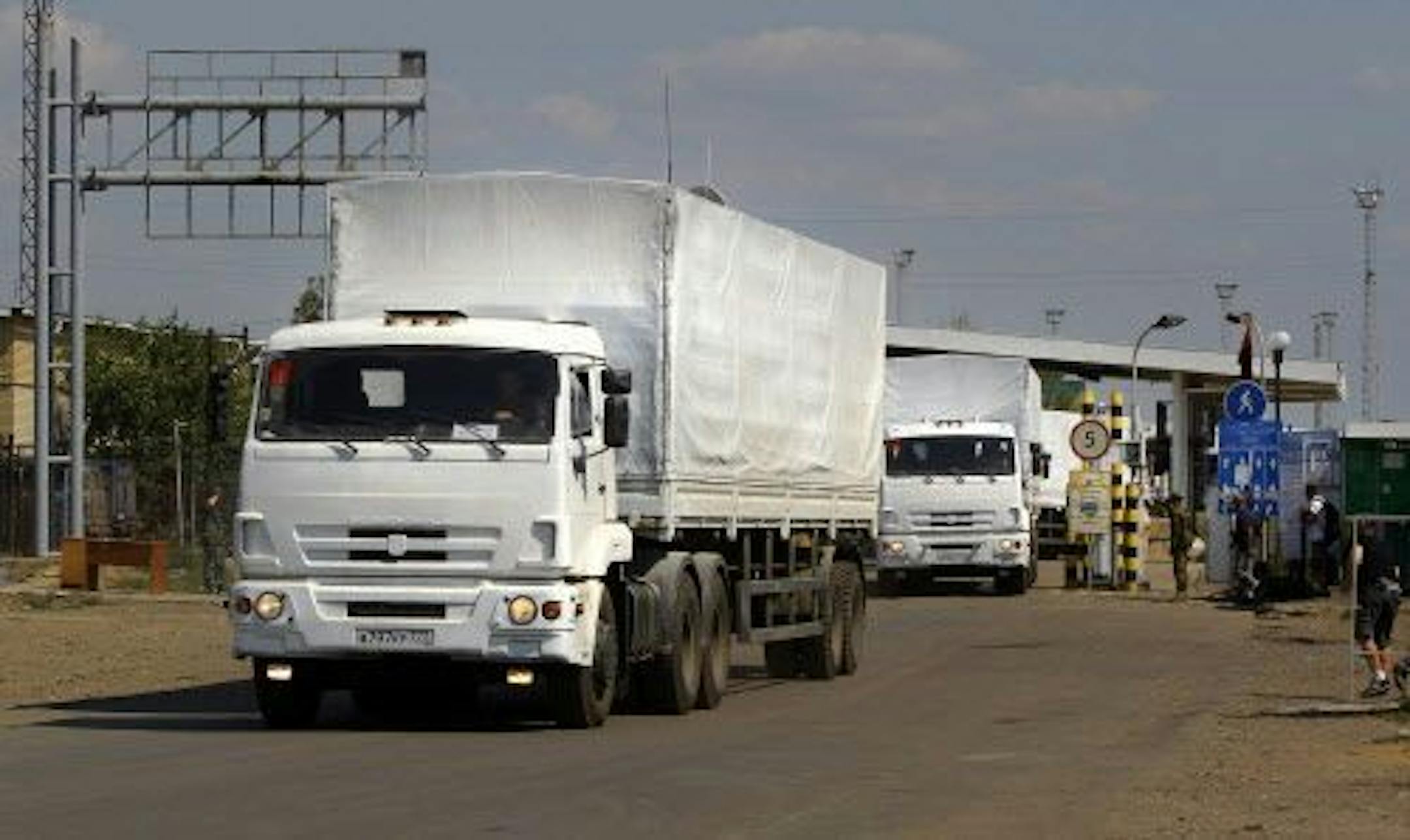 The first trucks of the aid convoy pass the border post at Izvaryne, eastern Ukraine, Friday, Aug. 22, 2014.