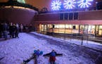 Isabelle Harris, 4, left, and Ellis Paulsen, 4, made snow angels in the Civil Engineering Plaza during Friday night's Winter Light Show. The two just 