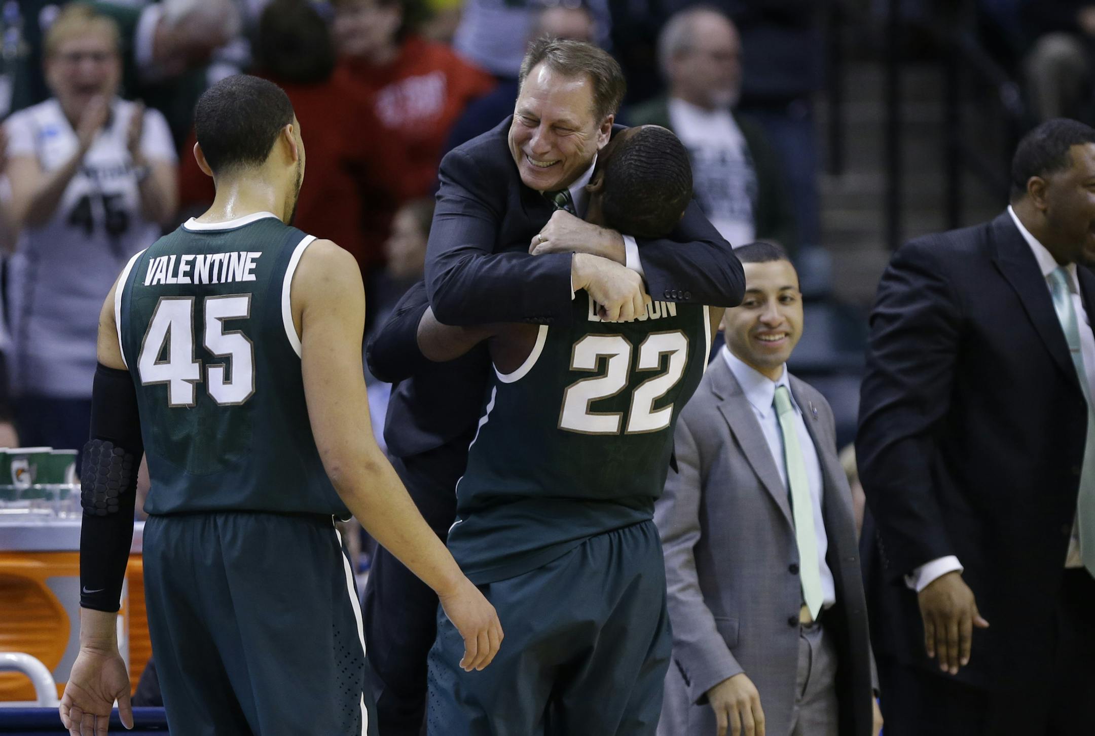 Michigan State guard/forward Branden Dawson hugs head coach Tom Izzo as he wake to the bench in the second half of an NCAA college basketball game in the championship of the Big Ten Conference tournament Sunday, March 16, 2014, in Indianapolis. Michigan State won 69-55. (AP Photo/Michael Conroy)