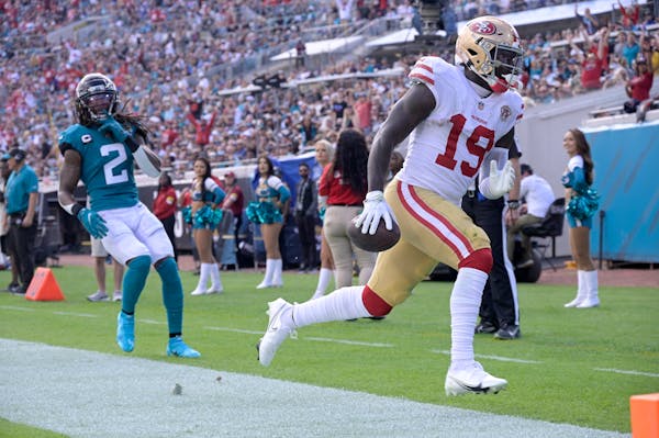 49ers wide receiver Deebo Samuel ran for a touchdown past Jaguars safety Rayshawn Jenkins on Sunday.