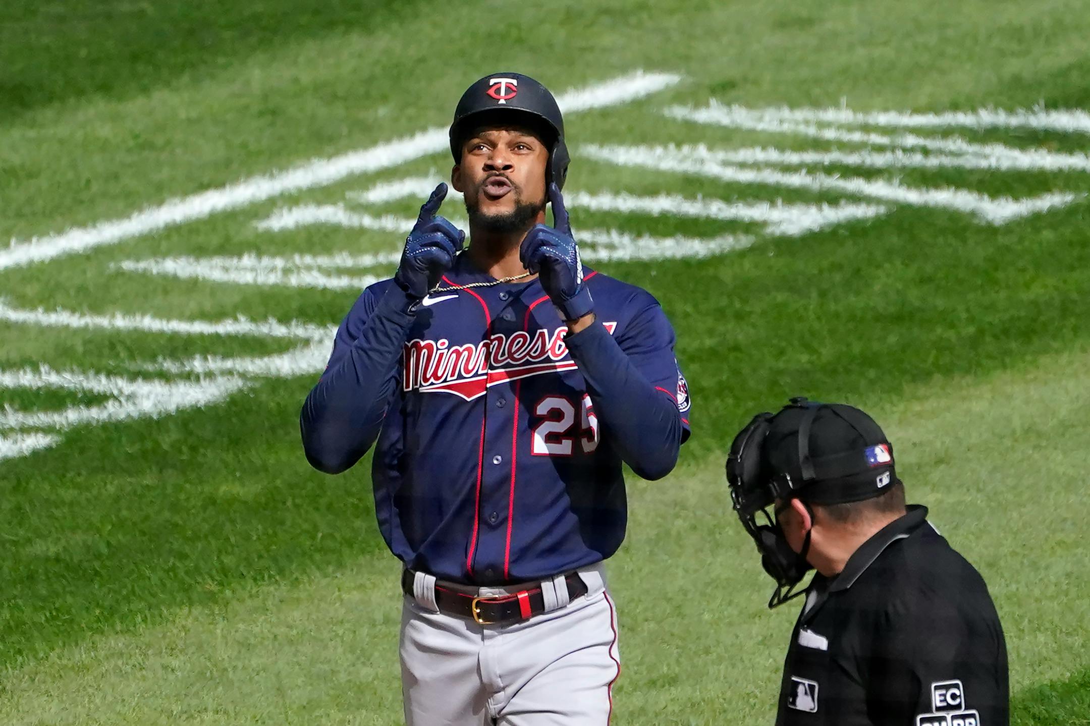 Minnesota Twins' Byron Buxton celebrates his second home run of the game off Chicago White Sox starting pitcher Reynaldo Lopez as home plate umpire Dan Bellino watches during the fifth inning of a baseball game Thursday, Sept. 17, 2020, in Chicago. Buxton earlier homered in the second. (AP Photo/Charles Rex Arbogast)