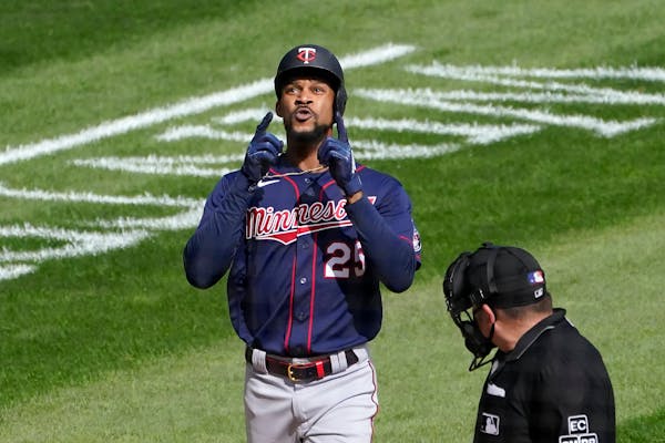 Minnesota Twins' Byron Buxton celebrates his second home run of the game off Chicago White Sox starting pitcher Reynaldo Lopez as home plate umpire Da