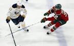 Buffalo Sabres' Tyler Ennis, left, controls the puck against Minnesota Wild's Nate Prosser in the first period of an NHL hockey game Tuesday, Nov. 1, 