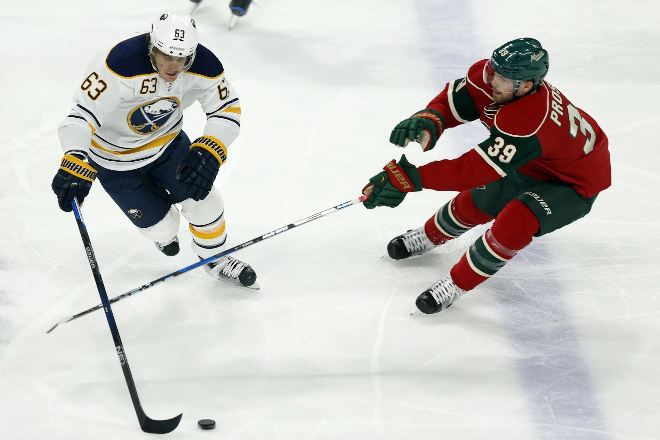Buffalo Sabres' Tyler Ennis, left, controls the puck against Minnesota Wild's Nate Prosser in the first period of an NHL hockey game Tuesday, Nov. 1, 2016, in St. Paul, Minn.