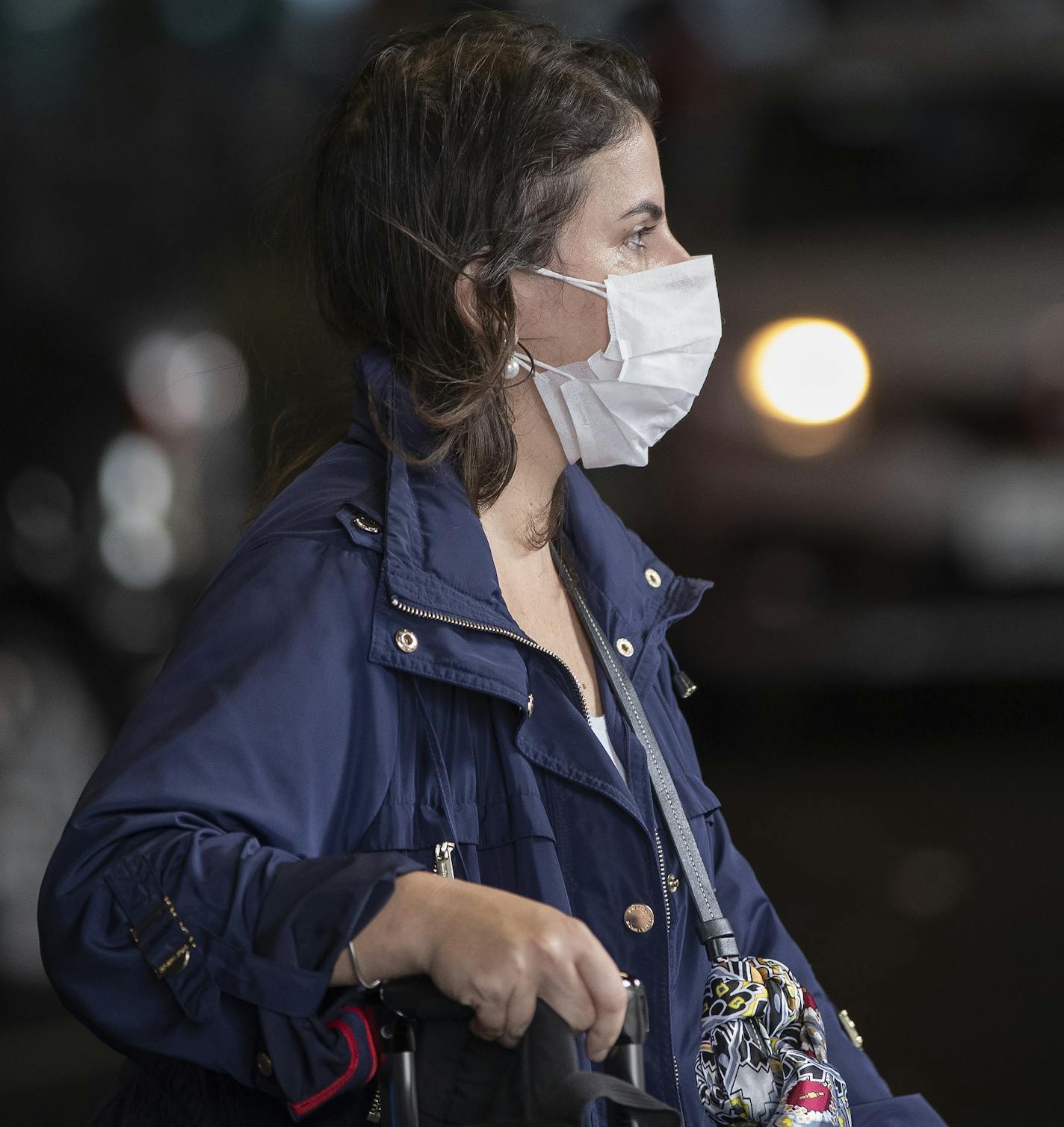 A passenger wearing a mask as a precaution against the spread of the new coronavirus COVID-19 arrives to the Sao Paulo International Airport in Sao Paulo, Brazil, Wednesday, Feb. 26, 2020. (AP Photo/Andre Penner)