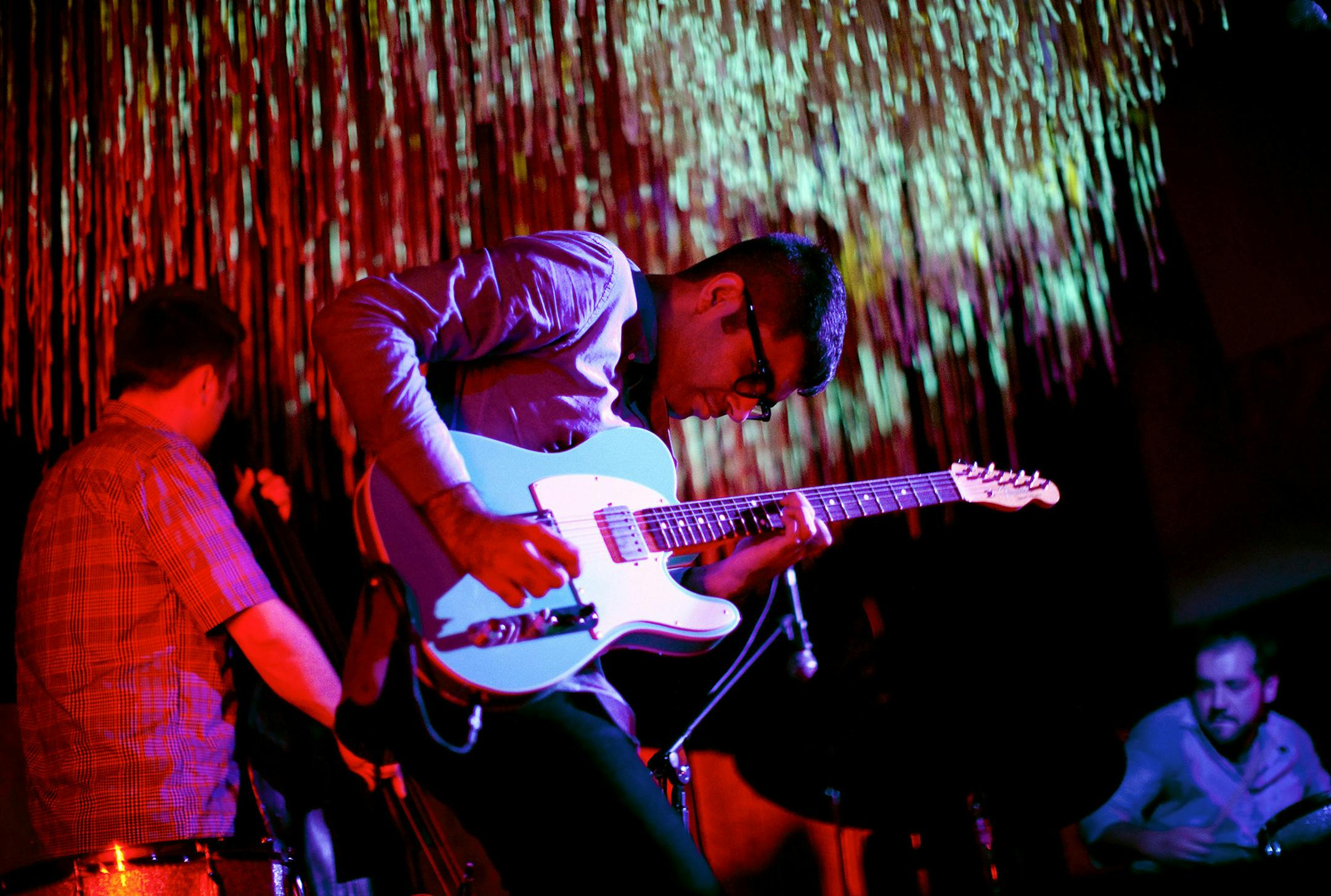 Rafiq Bhatia, guitarist, performs with Jackson Hill on bass, left, and Alex Ritz on drums at the Cameo Gallery in New York, Sept. 07, 2012. Bhatia has two recordings coming out soon, including an album, “Yes It Will.” (Brian Harkin/The New York Times) ORG XMIT: XNYT104