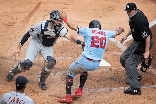 The Twins' Eddie Rosario was tagged out by Tigers catcher Grayson Greiner (17) in the fifth inning, trying to score on a bases-loaded double by Brent 