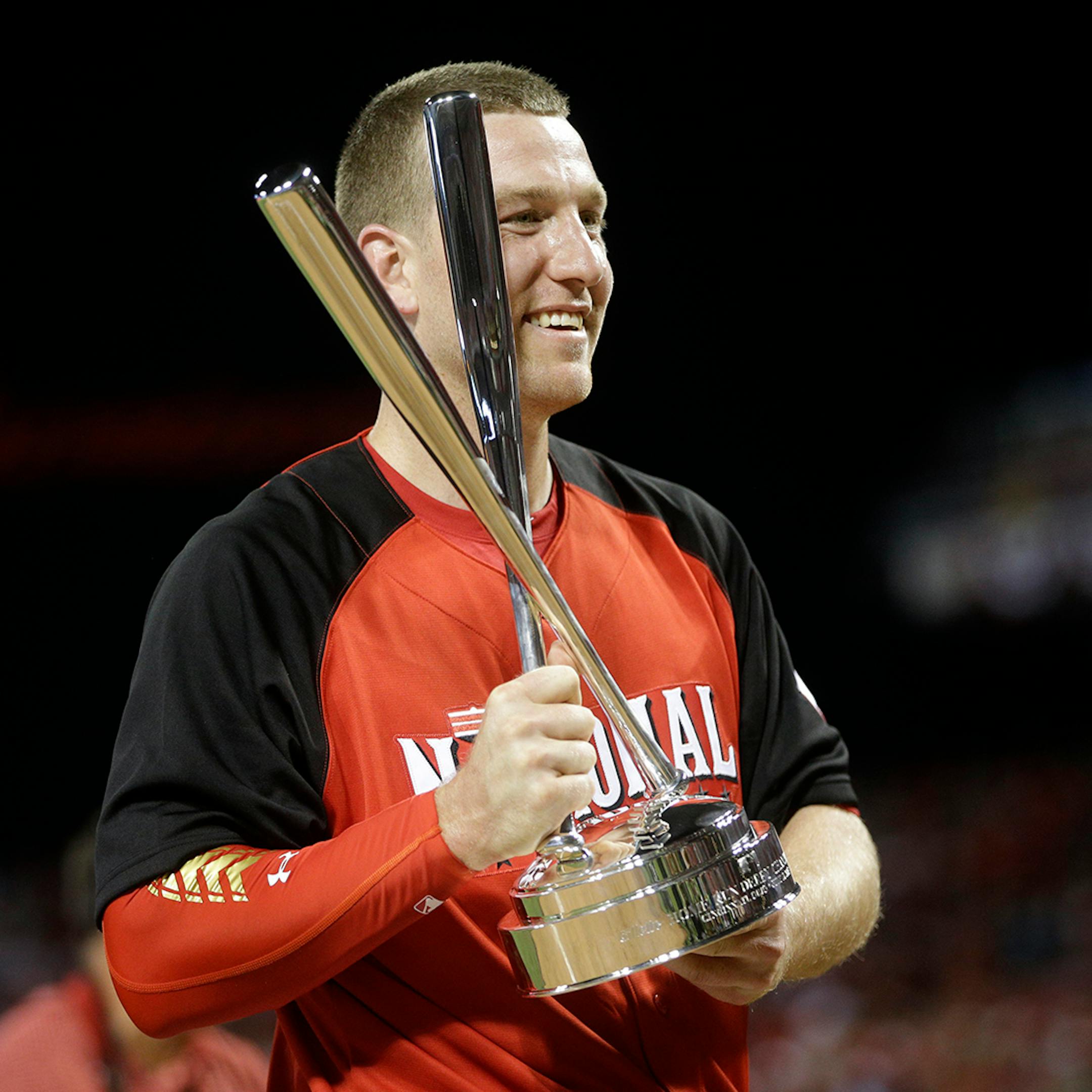 National League's Todd Frazier, of the Cincinnati Reds, holds the trophy after winning the MLB All-Star baseball Home Run Derby, Monday, July 13, 2015, in Cincinnati.