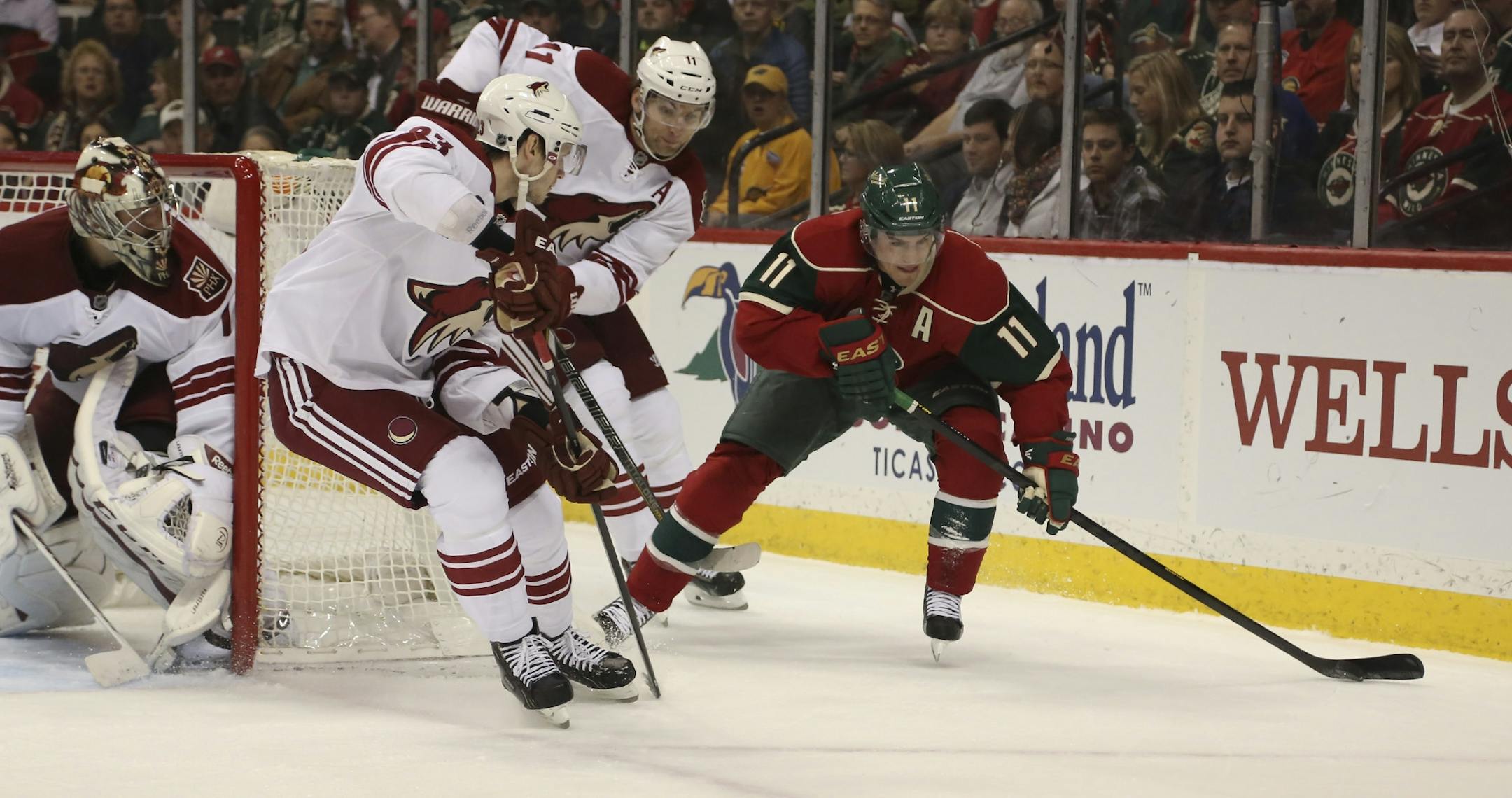 Zach Parise tried to skate passed the defense of Phoenix's Oliver Ekman-Larsson