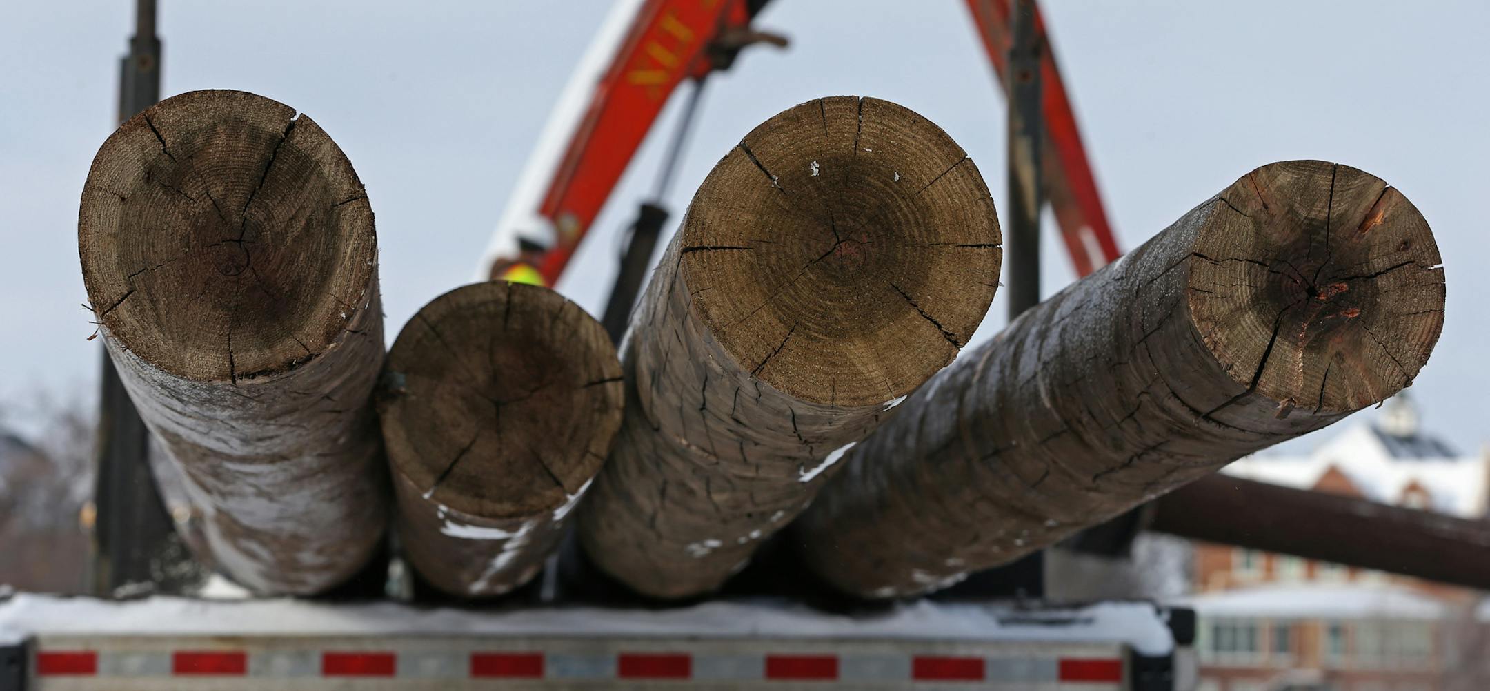 Brent Lindbery of Harry Lindbery Trucking delivered new power poles to a construction yard at the intersection of 7th Ave and Garfield in Anoka on 1/15/14. Great River Energy has begun work on a new 115 kilovolt power line that will improve service reliablity and avoid low power periods on high demand days in the Anoka area. Trees are being cleared along the transmission line path and wood utility poles and cross arms dropped off in January, said Great River spokeswoman Lori Buffington. The $11