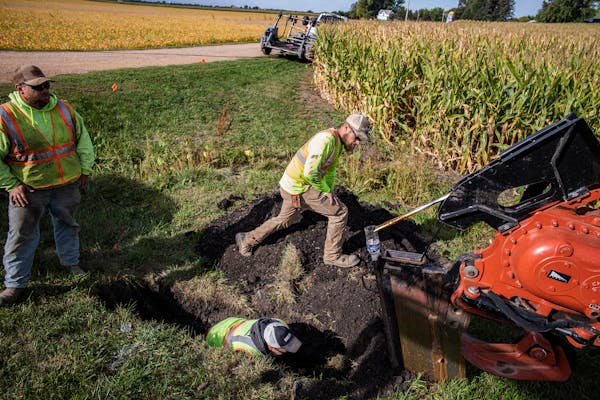 A crew lays down fiber-optic cable in Carver County, Minn., in 2022.
