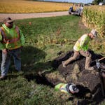 A crew lays down fiber-optic cable in Carver County, Minn., in 2022.
