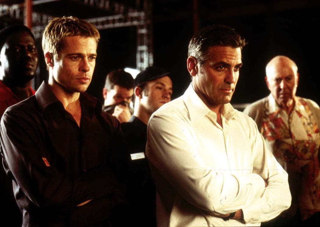 Rusty Ryan (Brad Pitt, left) and Danny Ocean (George Clooney) in “Ocean’s Eleven.”