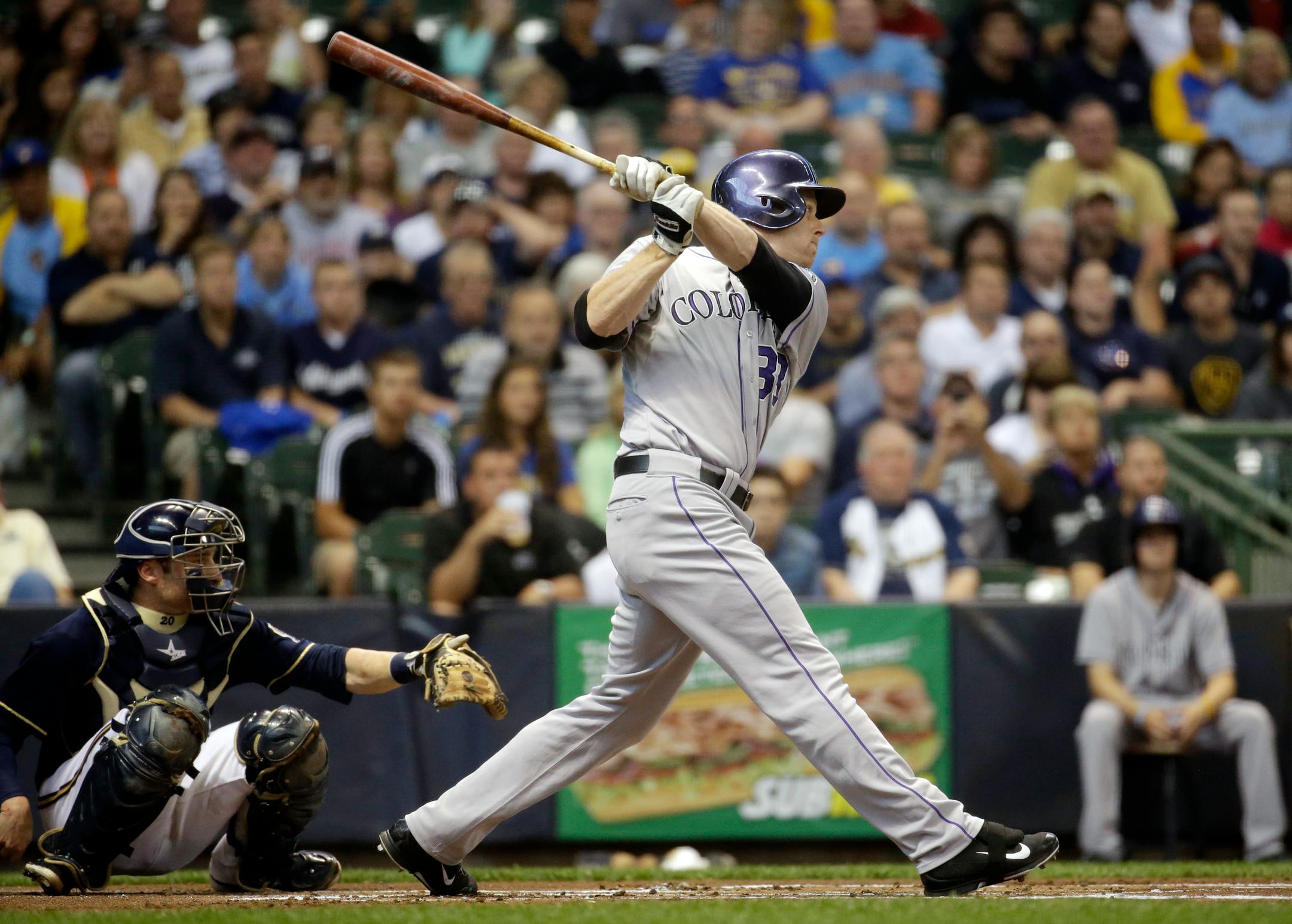 Colorado Rockies' Justin Morneau hits a double during the first inning of a baseball game against the Milwaukee Brewers Thursday, June 26, 2014, in Milwaukee. (AP Photo/Morry Gash)