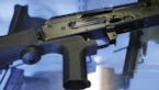 FILE - In this Oct. 4, 2017, file photo, a device called a "bump stock" is attached to a semi-automatic rifle at the Gun Vault store and shooting rang