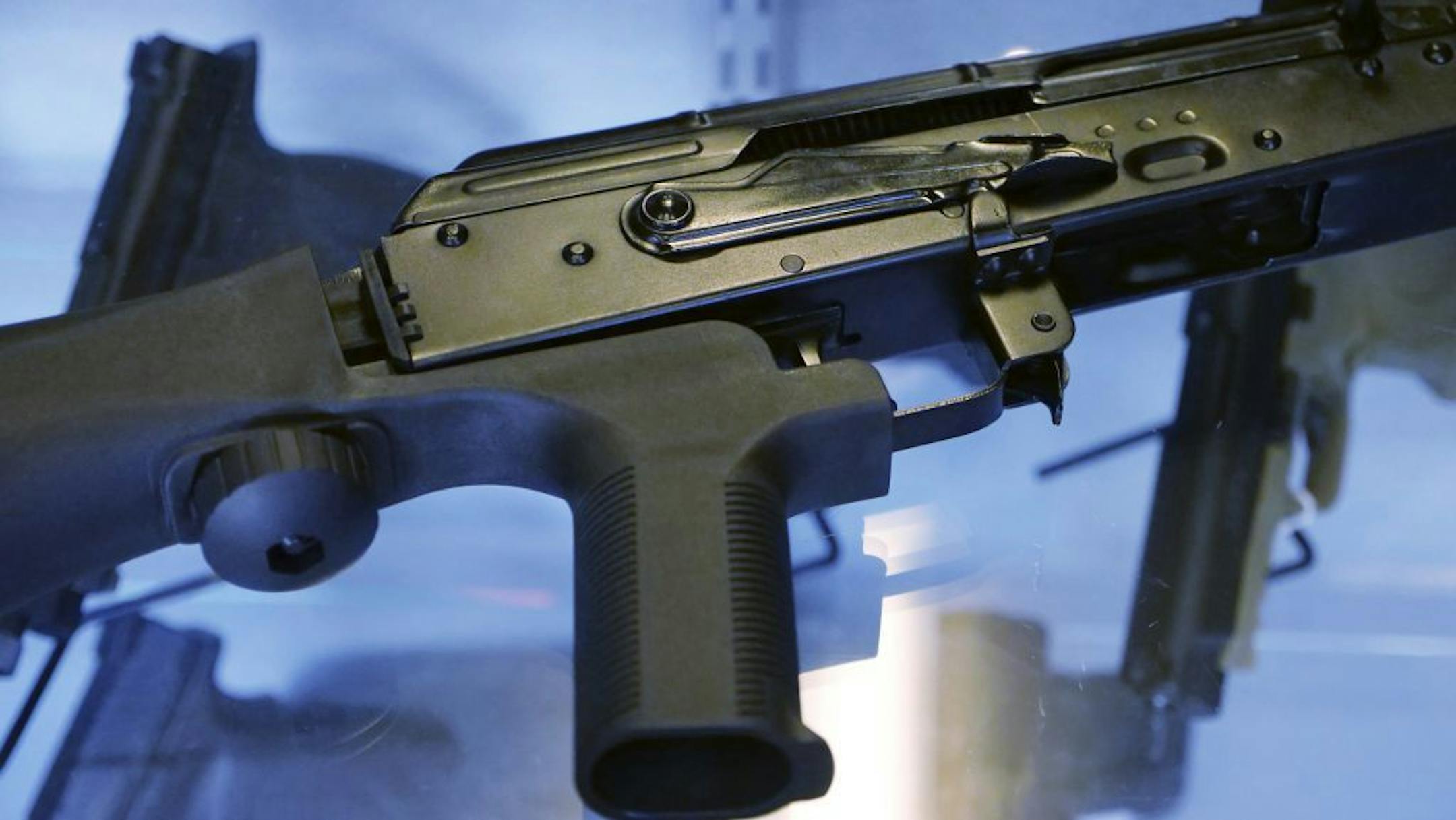 FILE - In this Oct. 4, 2017, file photo, a device called a "bump stock" is attached to a semi-automatic rifle at the Gun Vault store and shooting range in South Jordan, Utah. Some states and cities are taking the lead on banning bump stocks as efforts stall in Washington. The controversial device was used in the Las Vegas shooting, allowing a semi-automatic rifle to mimic a fully automatic firearm. Gun-control advocates say the push fits a pattern in gun politics: inaction in Washington that for