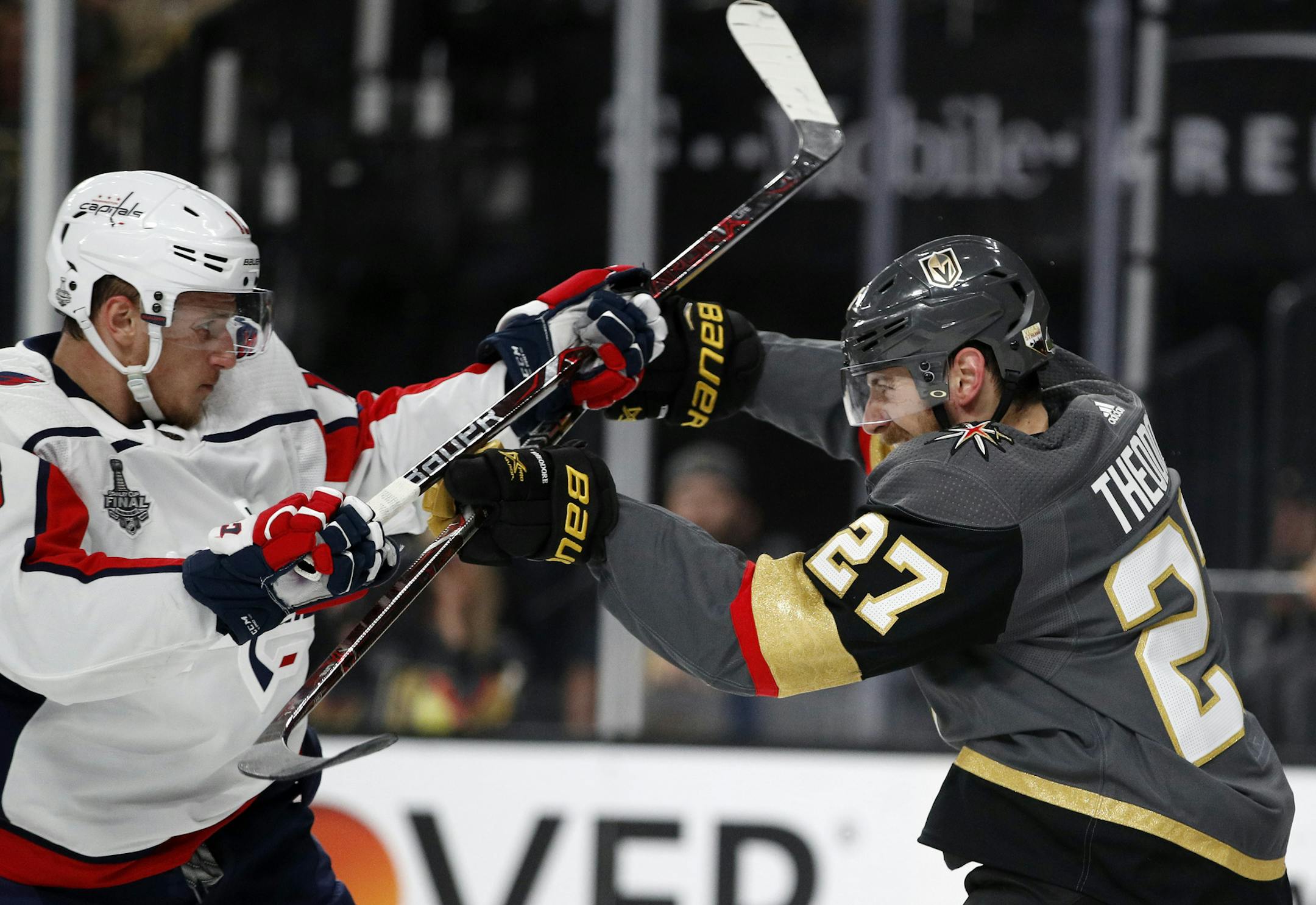 Washington Capitals left wing Jakub Vrana, left, of the Czech Republic, and Vegas Golden Knights defenseman Shea Theodore scuffle during the first period in Game 2 of the NHL hockey Stanley Cup Finals on Wednesday, May 30, 2018, in Las Vegas. (AP Photo/John Locher)