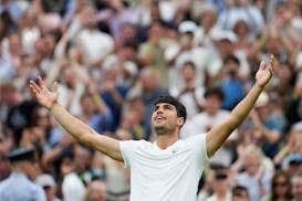 Carlos Alcaraz celebrates after defeating Francis Tiafoe in five sets in their third-round match at the Wimbledon tennis championships on Friday.
