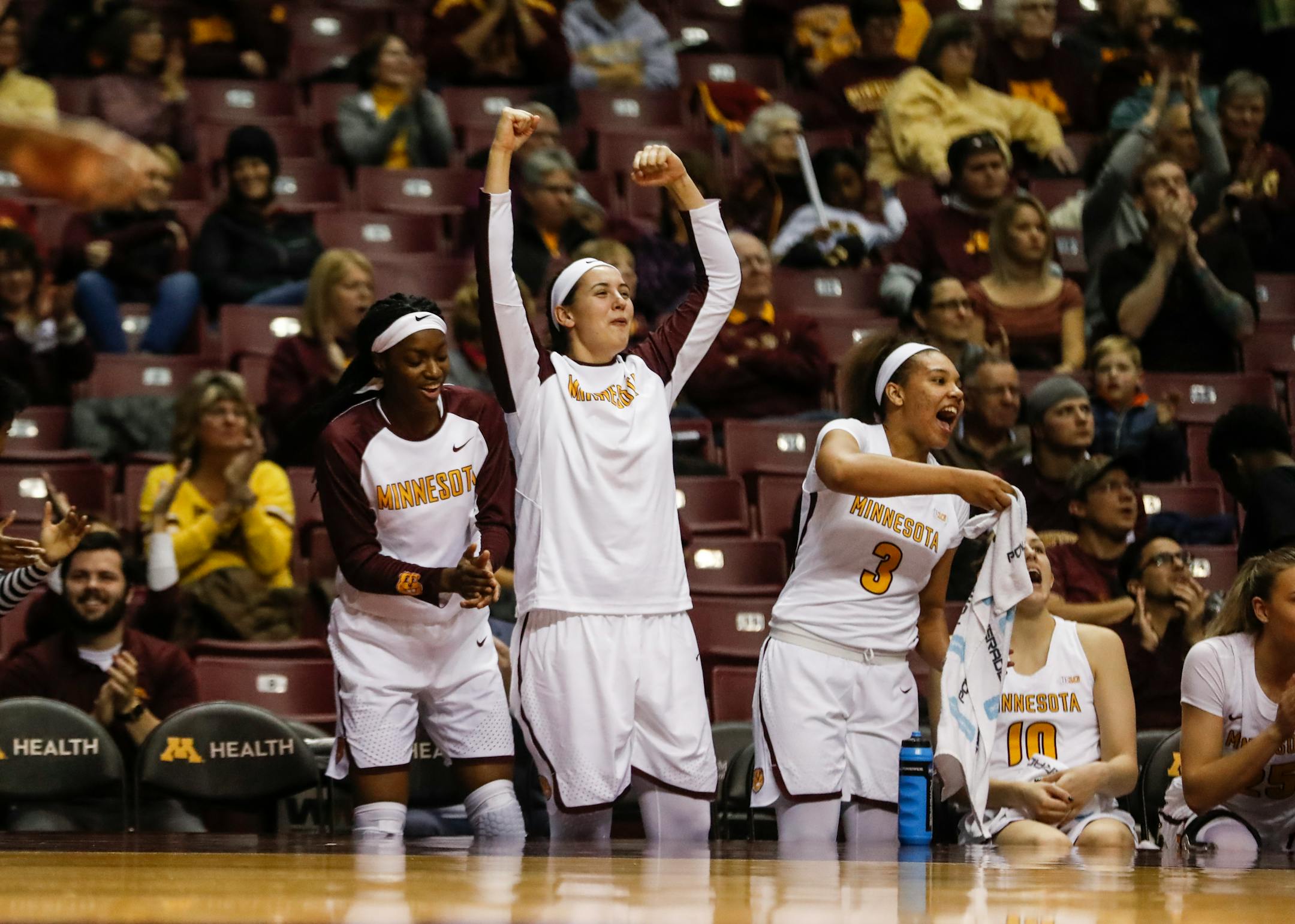 Teammates cheered as the Gophers scored during the third quarter.