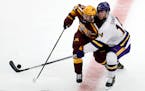 Minnesota's Ben Meyers (39) and Minnesota State ma's Ryan Sandelin (14) vie for the puck during the second period of an NCAA men's Frozen Four college